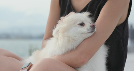 Woman play with her dog at outdoor street