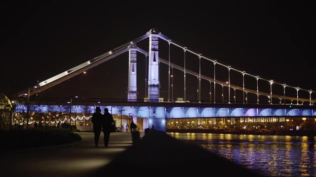 Walking street promenade and highlighted night crimean bridge in Moscow City