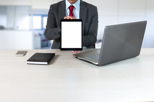 Businessman holding a tablet computer in his office