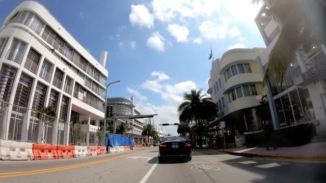 MIAMI BEACH, FL - APRIL 11, 2018: Time lapse of traffic along Collins Ave as seen from moving car. Miami is the major city of Florida