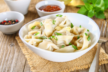 Homemade ready dumplings on an old wooden table.