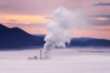 Power Plant at sunrise at a misty valley