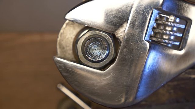 A mechanic removing a nut with a large wrench