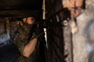 Arab soldier aiming with Kalashnikov AK-47 assault rifle