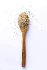 Spoon full of quinoa grains on white background
