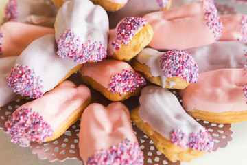 Eclairs with pink icing, closeup
