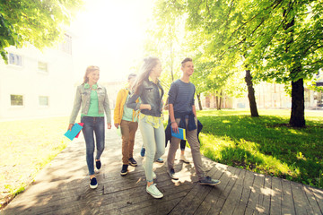 education, high school, learning and people concept - group of happy teenage students walking...