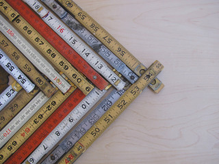 Rulers and scales in metric and inches form a chevron chart or graph representing accuracy,...