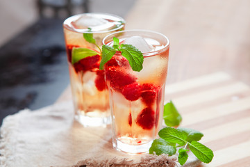 Refreshing summer drink with raspberry, mint and ice copy space - obrazy, fototapety, plakaty