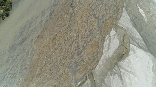 Parched river in mountain province Luzon, Philippines. Aerial view Drought in mountain valley, dry and shallow Bucao river.