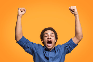 Fototapeta premium Winning success man happy ecstatic celebrating being a winner. Dynamic energetic image of male model
