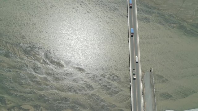 Modern bridge over river with cars in a mountain province Philippines,Luzon. Aerial view Bucao Bridge.