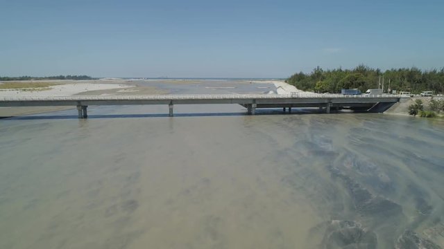 Modern bridge over river with cars in a mountain province Philippines,Luzon. Aerial view Bucao Bridge.
