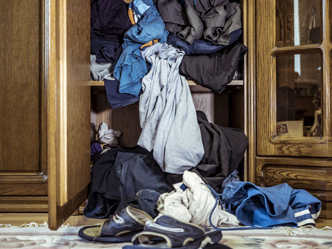 Close Up Of Big Pile Of Messy Clothes Thrown On The Floor Near The Wardrobe