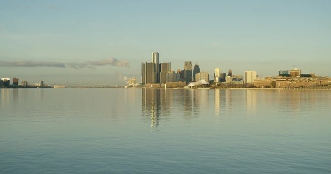Wide Tilt Down Reveal From Detroit River To Downtown Cityscape At Sunrise