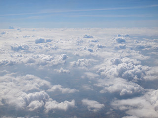 Fototapeta na wymiar Blue sky with clouds, a view from airplane window