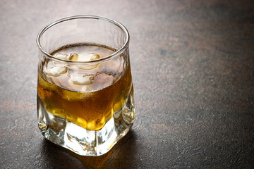 Whiskey with ice in glass