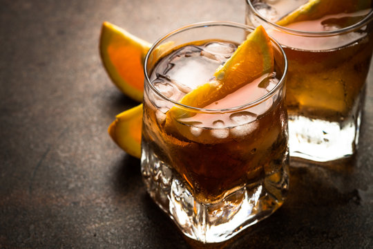 Negroni cocktail in glass on dark. 