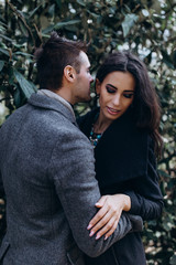 Fashion engagement shooting, photo session for beautiful couple, walk of a couple in love around the city and park.