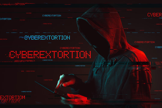 Cyberextortion concept with faceless hooded male person