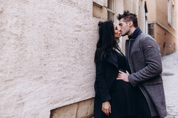 Fashion engagement shooting, photo session for beautiful couple, walk of a couple in love around the city and park.