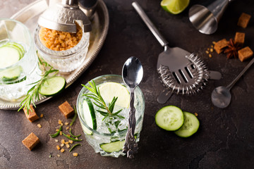 Green alcohol cocktail with cucumber and rosemary