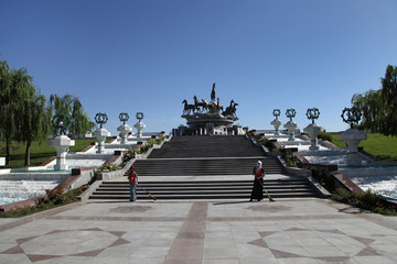Ashgabat, Turkmenistan - October 26, 2014.  Women sweep the area near the monument.  Ashgabat,...