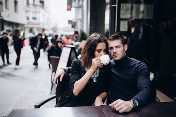 Fashion engagement shooting, photo session for beautiful couple, walk of a couple in love around the city and park.