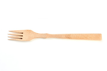 Wooden fork isolated on white background. Kitchen fork made of wood. Concept of natural kitchenware.