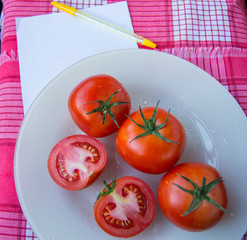 sheet Notepad for recording with tomato on white dish