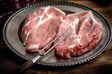 Slices of raw pork neck.