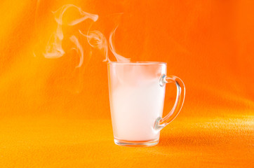Mug with smoke on an orange background