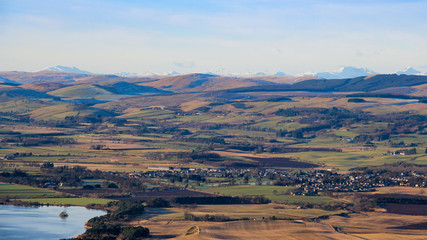 View West from the Lomond Hills towards Milnathort, Loch Leven, and distant snow-covered mountains,...