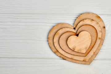 Happy Valentines Day wooden background. Collection of plywood hearts and copy space. Valentines holiday greeting card.