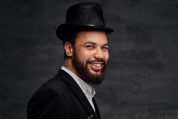 Smiling African-American man in an elegant suit and black hat.
