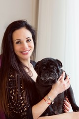 Life of pug breed dogs. Pets and woman. Girl dog lover hugging dog breed Mops 