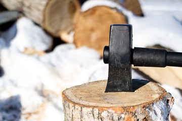 firewood choker metal and plastic handle stuck in the stump around a lot of wood