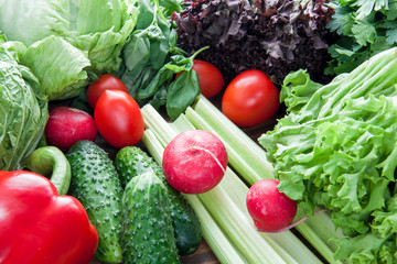 ripe tomatoes, peppers, radish and salad on the table for cooking vegetarian food