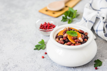 beans in a pot on concrete background. Selective focus, space for text.