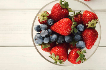 Mixed berries in glass bowls closeup, top view