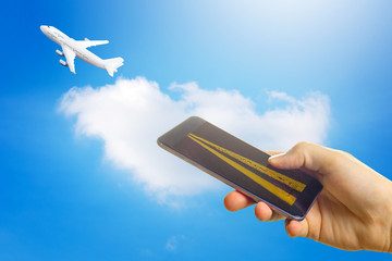 Buying airline tickets online concept. Smartphone or mobile phone with runway . the airplane takes off .
