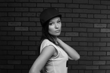 serious girl posing in a black cap