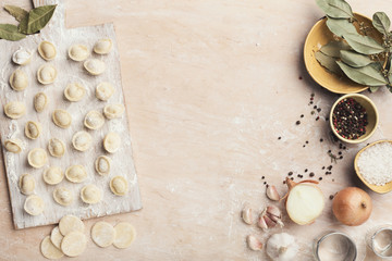 Fototapeta na wymiar Dumplings on the table with flour, layout for recipe