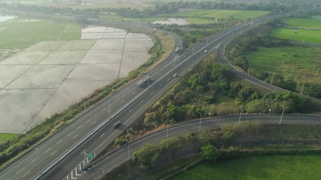 Aerial View Highway With Cars Among Farmer Fields, Rice Terraces. Philippines, Luzon. High Speed Highwayin The Morning Sunrise.Tropical Landscape In Asia.