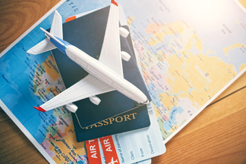 Plane model with world map, passports and tickets as airplane traveling and tickets booking concept - 203969862