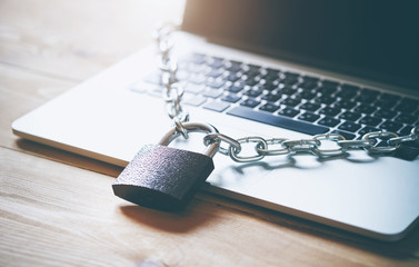 Locked chain on laptop as computer protection and cyber safety concept. Private data protection...