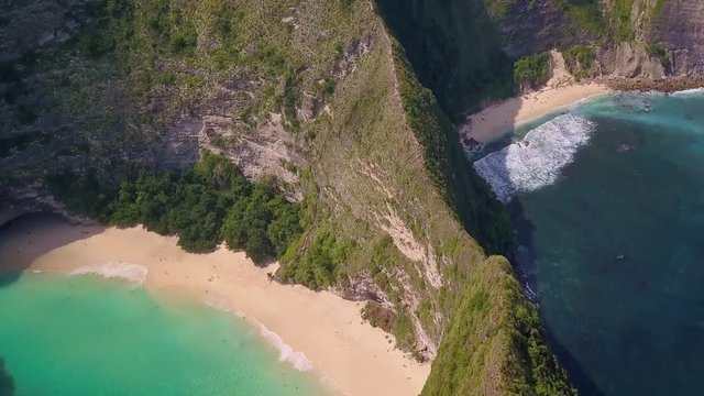 Aerial back tracking on stunning tropical Paradise beach and Cliff in Nusa Penida island of Bali Indonesia in amazing beautiful coast landscape  travel destinations and holidays concept 
