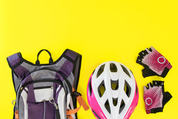 .Accessories for riding a bicycle on a bright yellow background.