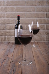 A glass of red wine on a wooden table