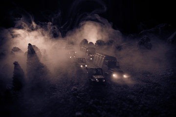 Obraz premium War Concept. Military silhouettes fighting scene on war fog sky background, World War Soldiers Silhouettes Below Cloudy Skyline At night. Attack scene. Selective focus Tanks battle. Decoration